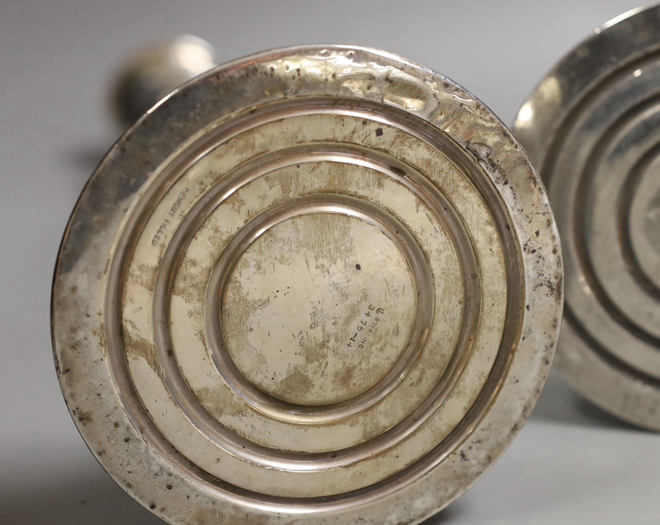 A pair of North American sterling candlesticks, with tapering stems, on circular bases, height 35.7cm, weighted.